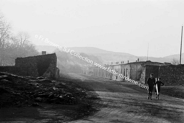 VIEW OF ROAD THROUGH CAR WINDSCREEN WITH HOUSES AT SIDE